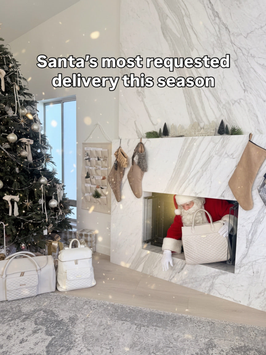 Santa's most requested delivery - Luli Bebe luxury white diaper bags under Christmas tree with Santa Claus