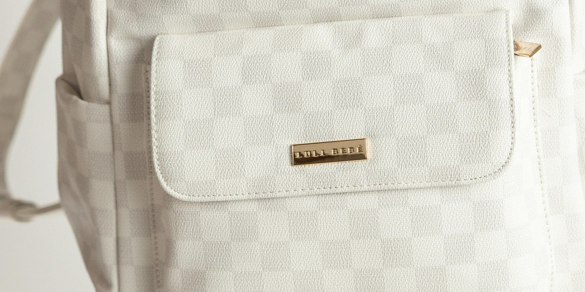 Checkered designer diaper backpack by Luli Bebé — the latest fashion-forward diaper bag style.