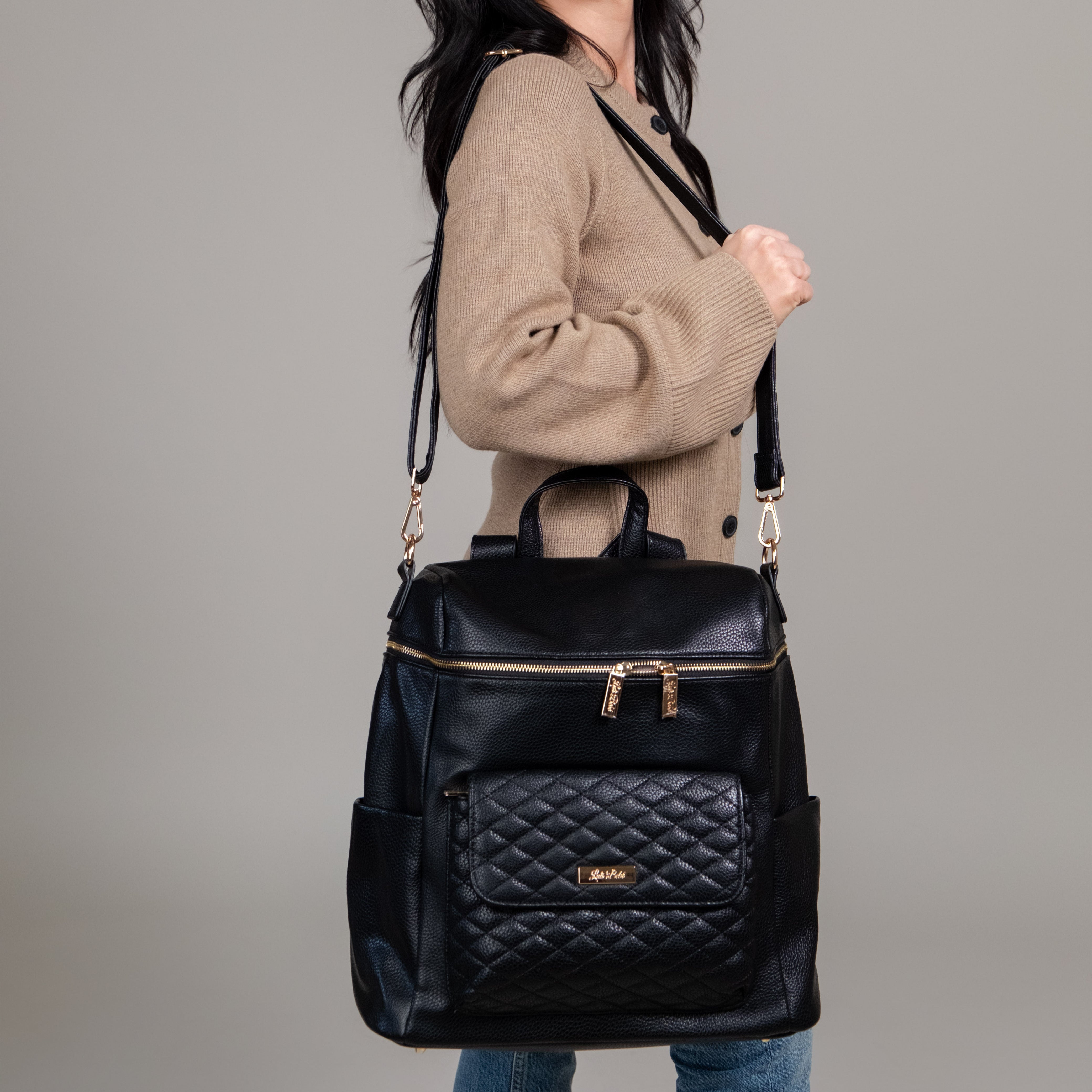 Stylish black diaper bag carried on shoulder by mom – Monaco collection by Luli Bebe, luxury vegan leather best-stylish backpack for everyday baby needs