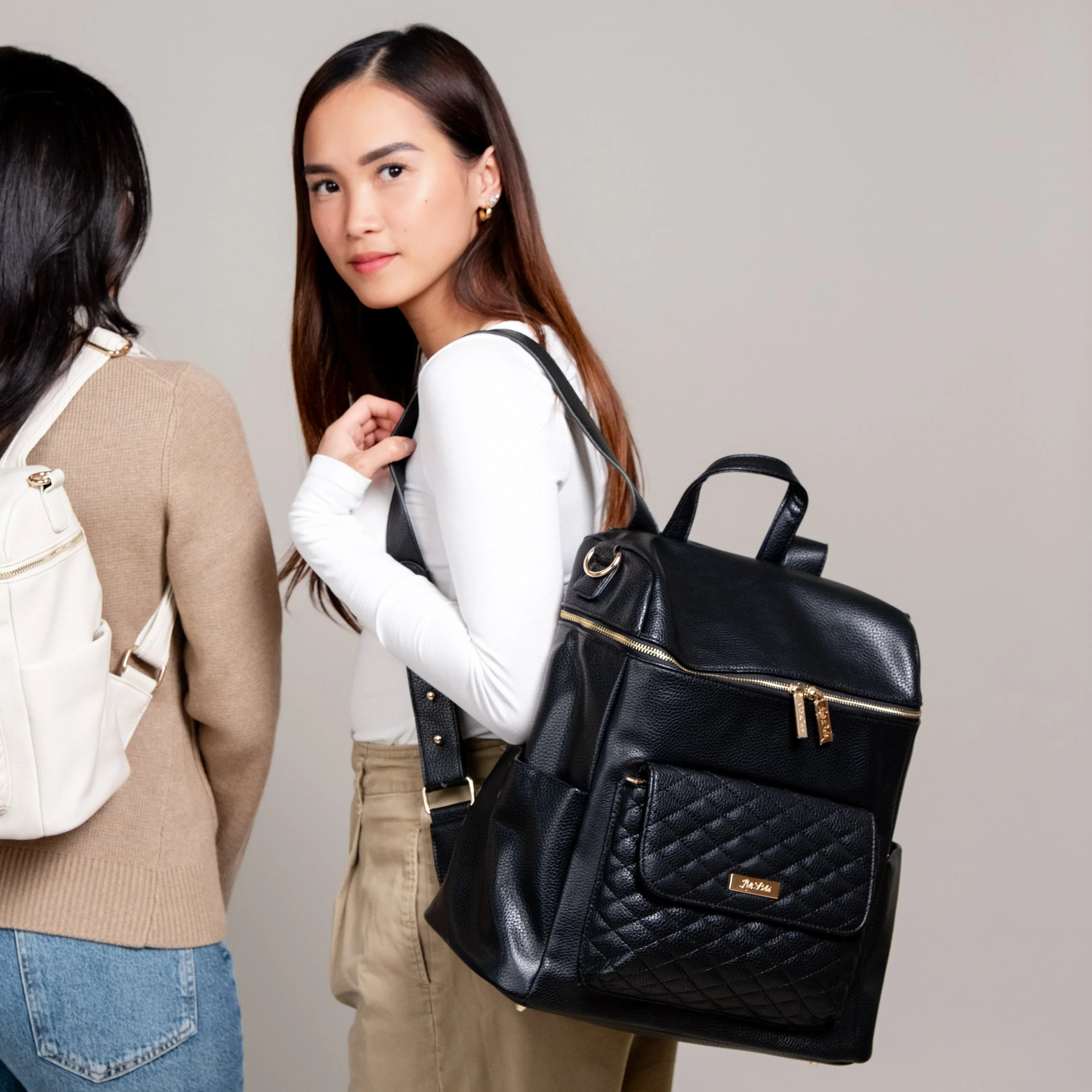 Mom wearing black diaper bag on shoulder – Monaco by Luli Bebe, stylish large backpack purse, practical and mom-approved for baby duties.