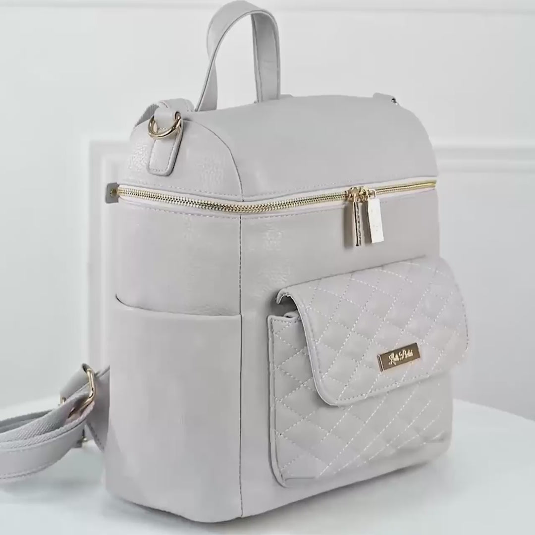 Video of Petit Monaco diaper bag by Luli Bebe highlighting details, pockets, stroller straps, and functional design for baby essentials