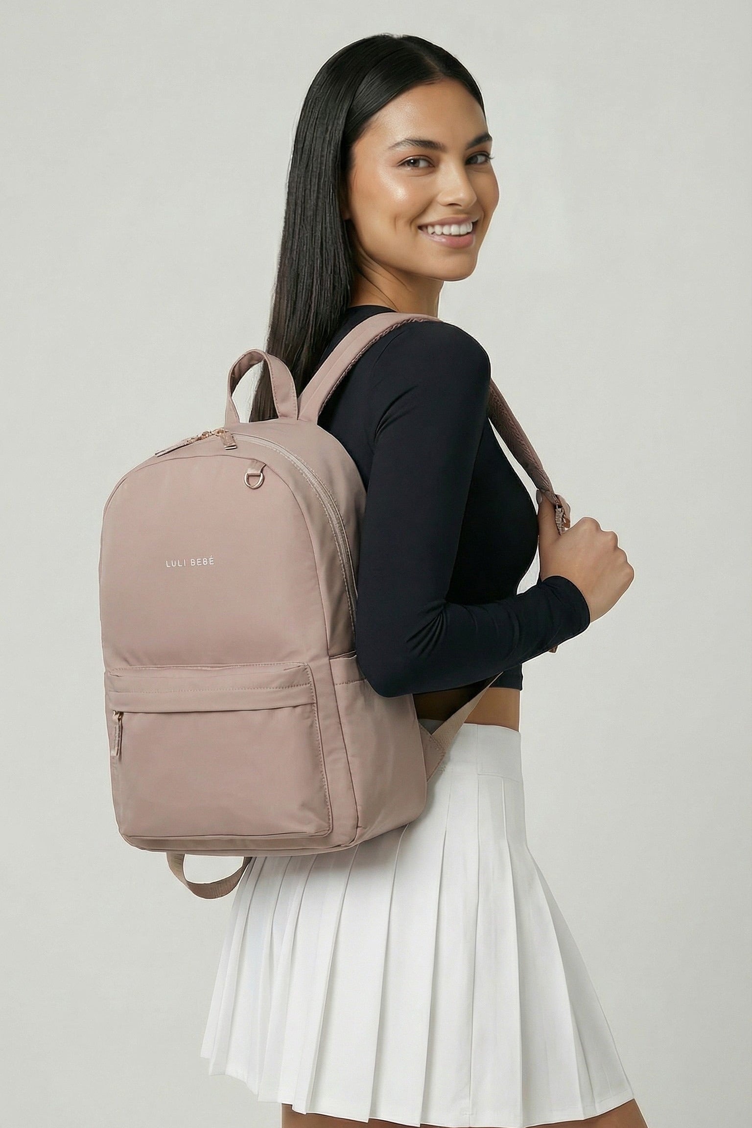 Blush Daily Backpack – lifestyle photo with model, everyday minimalist backpack worn on shoulder by Luli Bebé